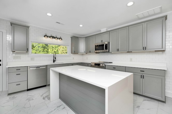 Kitchen with white cabinets and a center island